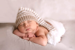 Newborn-Photography-Baby-with-striped-baby-hat