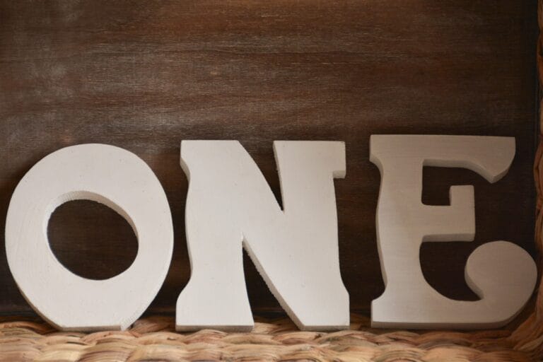 One letters for professional cake smash photography session in a New Malden studio for a baby’s first birthday.